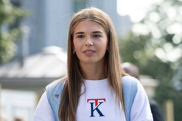 Kai Trump wearing a backpack and long-sleeve shirt