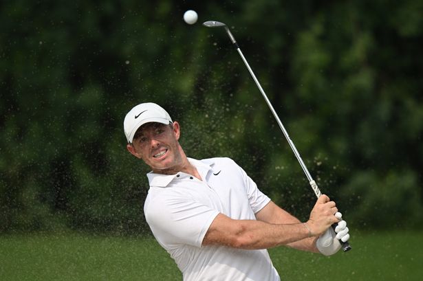 Rory McIlroy hits out from a bunker. 