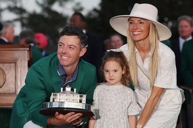 Rory McIlroy poses with his wife, Erica, and daughter, Poppy, after winning the Masters