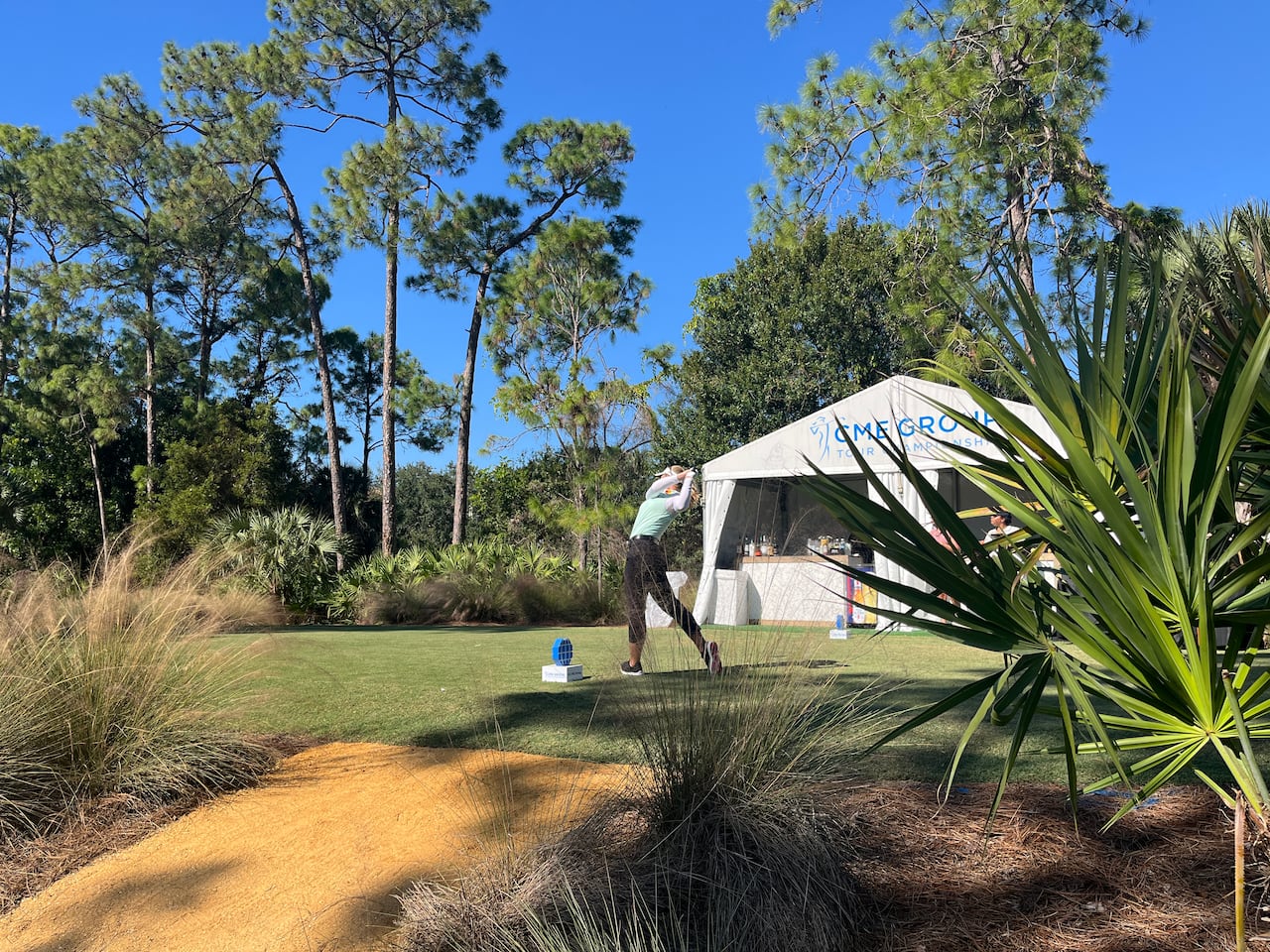 A golfer tees off during a practice round in Florida.
