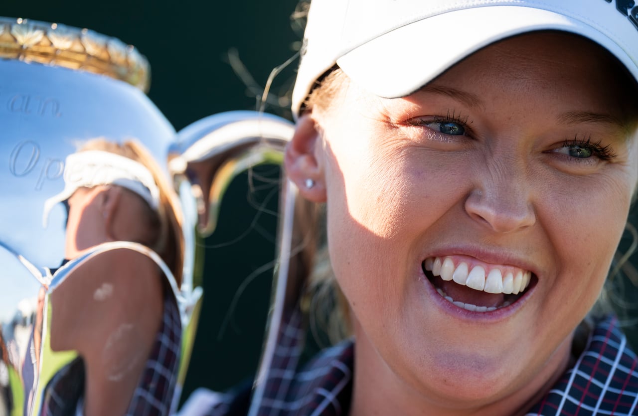 Canada's Brooke Henderson, professional golfer,  poses with the trophy after winning the CPKC Women's Open at the Mississauga Golf and Country Club in Mississauga, Ont., Sunday, Aug. 24, 2025.