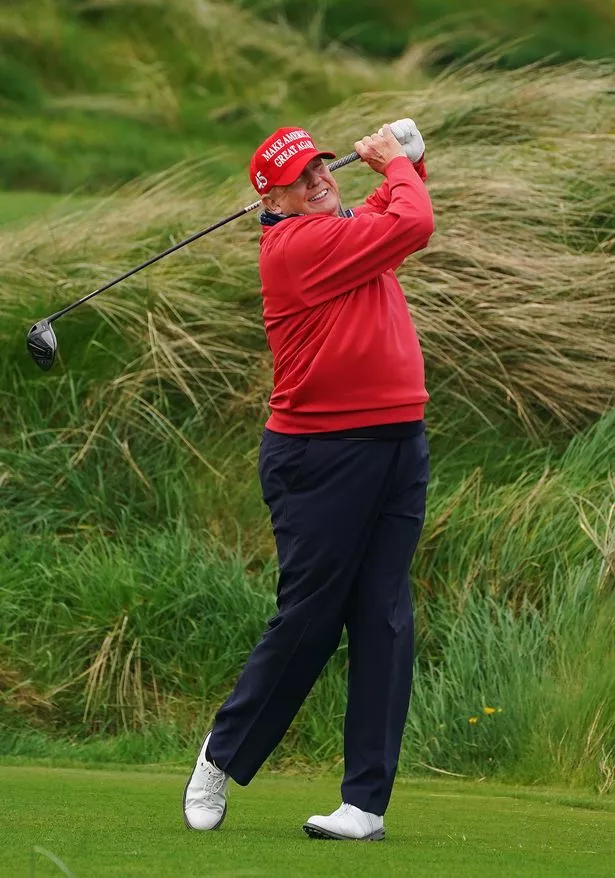 US president Donald Trump swings on the 4th tee at Trump International Golf Links in Ireland