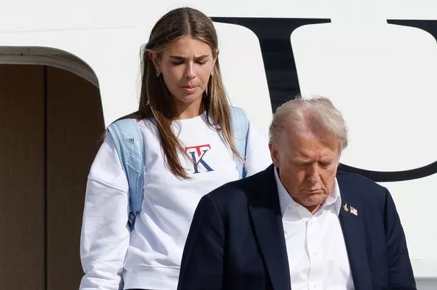 President Donald Trump down the stairs of Air Force One with his granddaughter Kai Trump