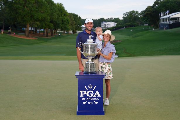 Scottie Scheffler poses with his son, Bennett, and his wife, Meredith Scudder after winning the 2025 PGA Championship.