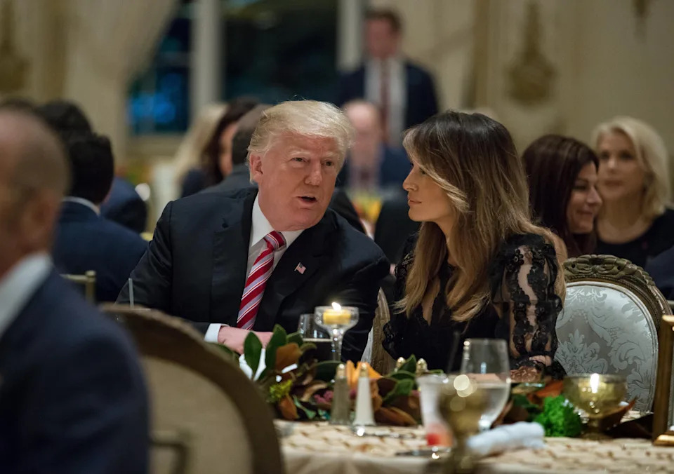 President Donald Trump, center, and first lady Melania Trump, sit with their family for Thanksgiving Day dinner at  Mar-a-Lago in Palm Beach on Nov. 22, 2018.