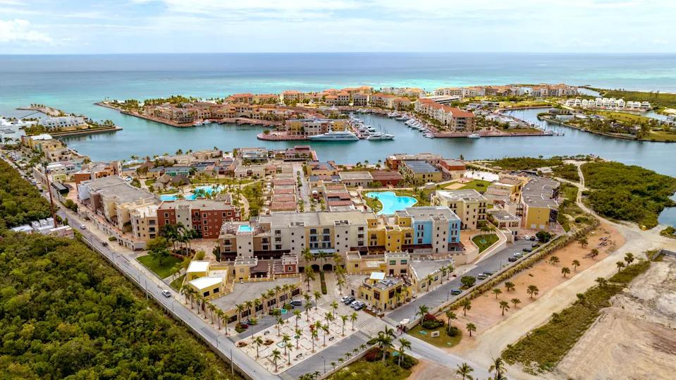 Aerial view of Marina Cap Cana in the Dominican Republic, showing luxury yachts, waterfront villas, and turquoise Caribbean water.