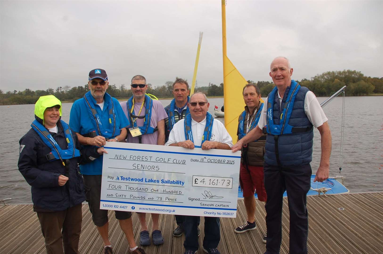 New Forest Golf Club seniors captain John Pickering (far right) with members and trustees of Testwood Lakes Sailability