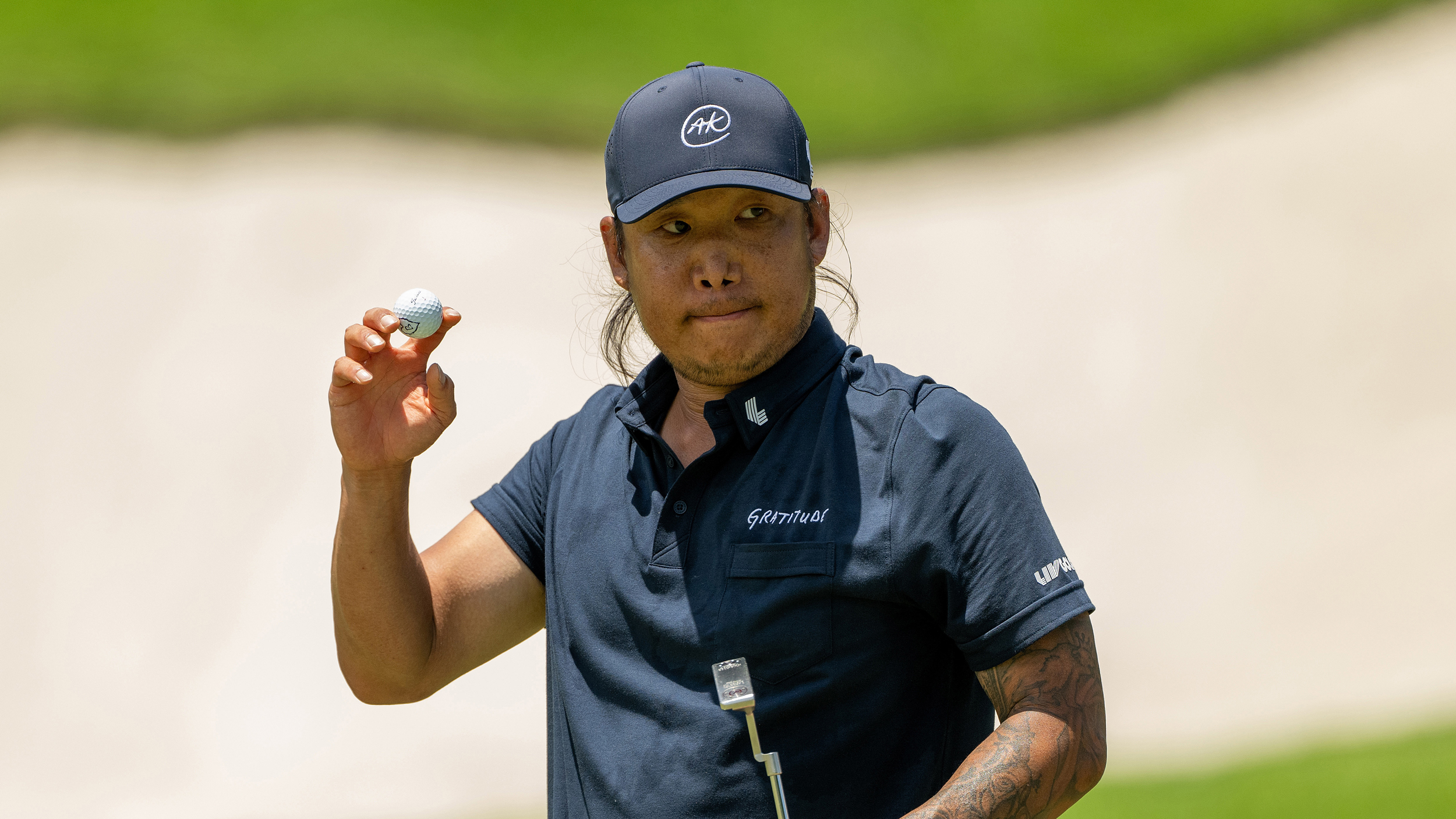Anthony Kim holds his ball up in acknowledgement to the crowd during the 2025 LIV Golf season