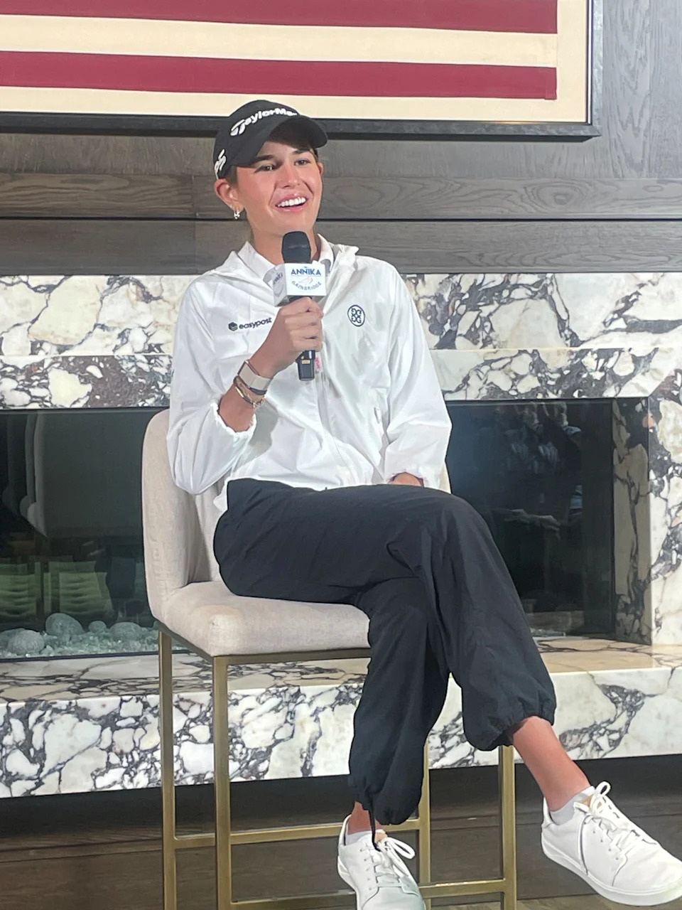 Kai Trump talks to the media at a press conference for the ANNIKA golf tournament.