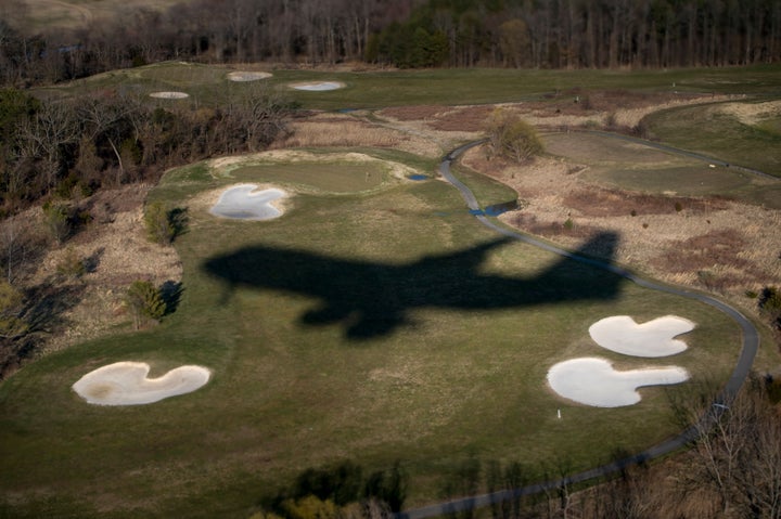 Air Force One's shadow is seen over Andrews Air Force Base's golf course while US President Donald Trump travels back to Washington from Mar-a-Lago March 25, 2018 in Maryland. (Photo by Brendan Smialowski / AFP via Getty Images)