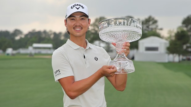 Min Woo Lee of Australia celebrates with the trophy after winning the Texas Children's Houston Open 2025 at Memorial Park Golf Course on March 30, 2025 in Houston, Texas. (Photo by Jonathan Bachman/Getty Images)