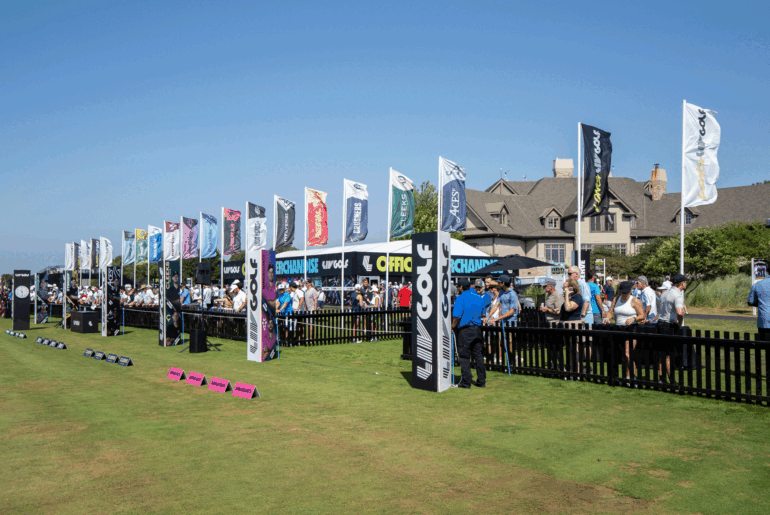 A general view of the driving range at LIV Golf Chicago with flags of all 13 teams flapping about behind the range