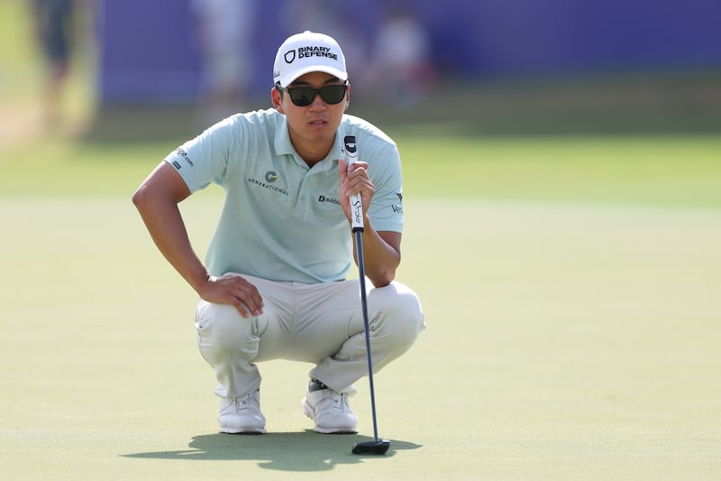 Michael Kim of the United States lines up a putt on the 18th green at Jumeirah Golf Estates in Dubai, UAE. Photograph: Andrew Redington/Getty