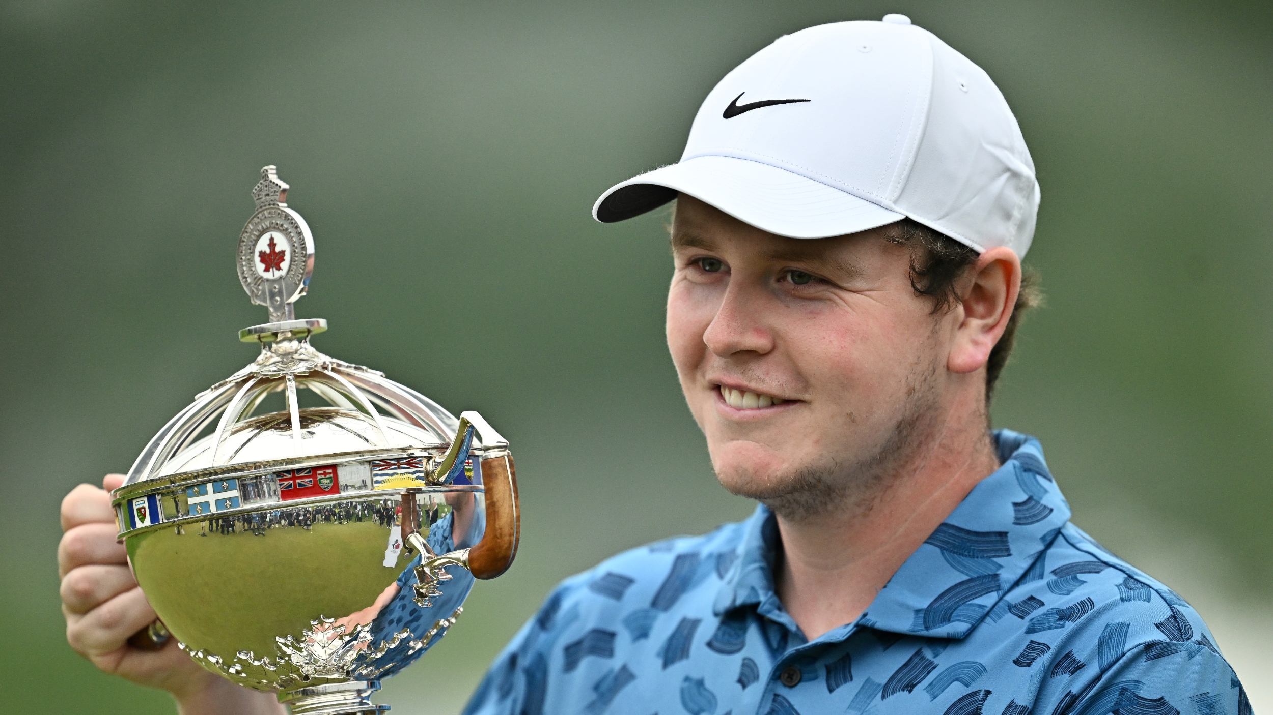 Robert MacIntyre smiling with the RBC Canadian Open trophy