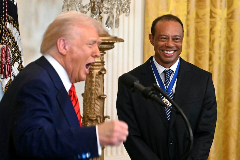 Donald Trump (left) awards the Medal of Freedom to Tiger Woods (right)