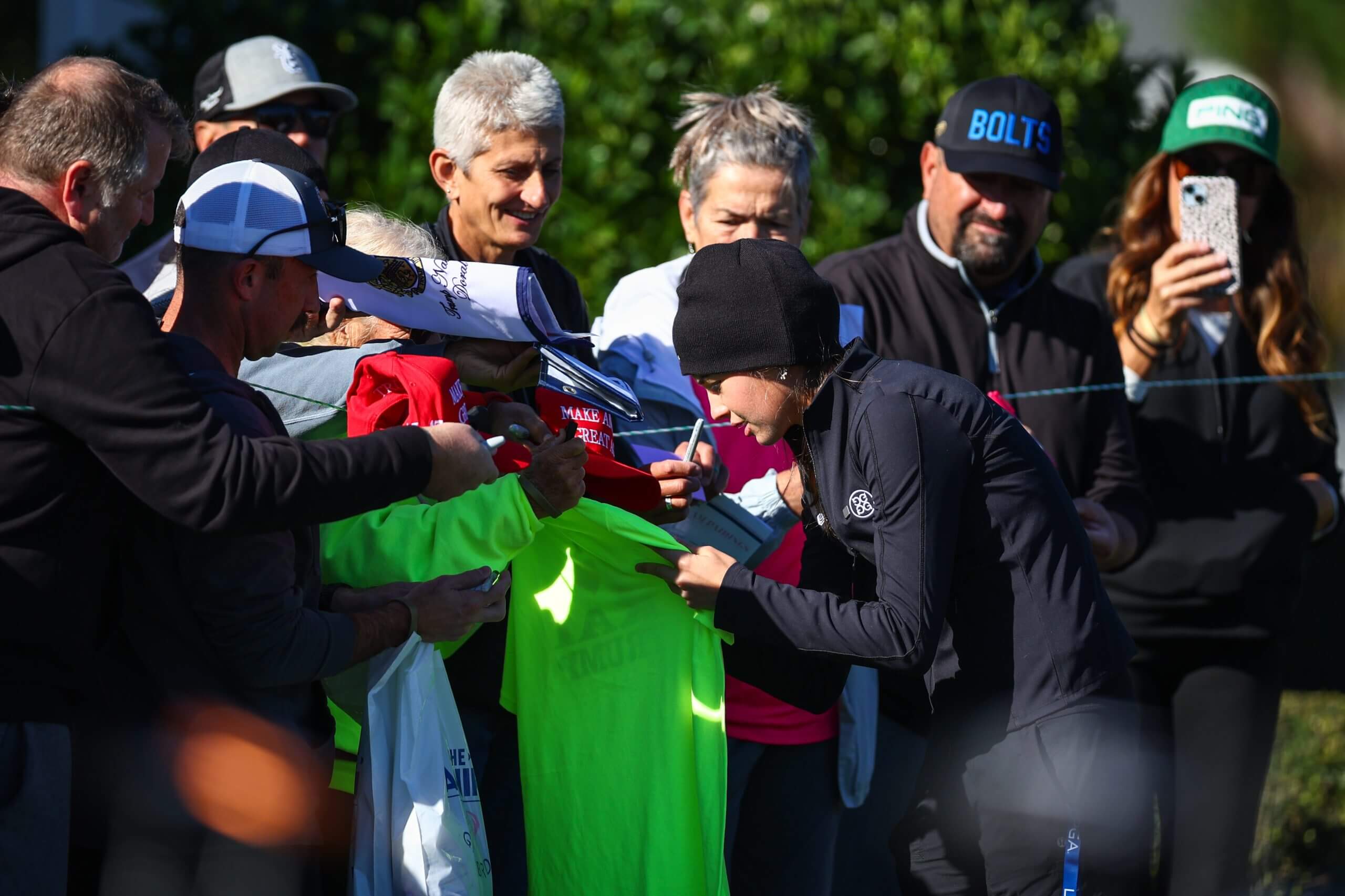 Kai Trump signs autographs before a practice round at The Annika LPGA tournament.