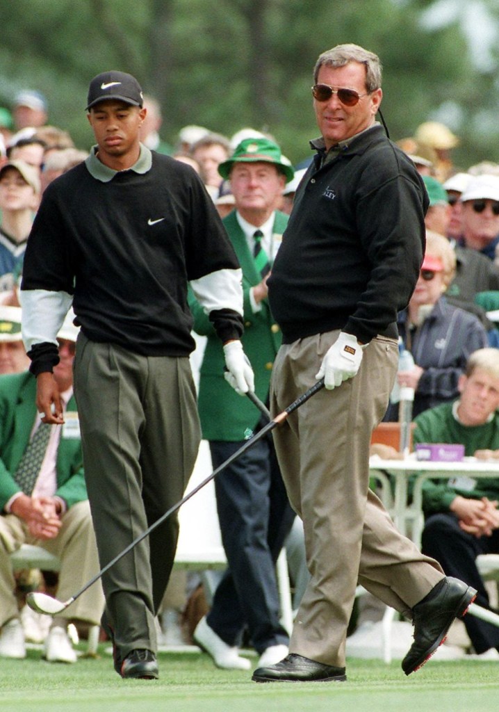 AUGUSTA, :  US golfer Tiger Woods (L) approaches partner Fuzzy Zoeller (R) as they tee off from the first hole 10 April during second round action at the 1998 Masters at Augusta National Golf Course in Augusta, GA. Both golfers started the round 1-under-par.     AFP PHOTO/Timothy A. CLARY (Photo credit should read TIMOTHY A. CLARY/AFP via Getty Images)