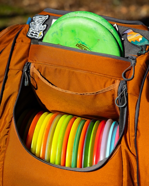 Andrew Fish, designer of the Northwest Branch Disc Golf Course, brings a collection of discs with different uses to play with in Cloverly, MD on November 17, 2025.