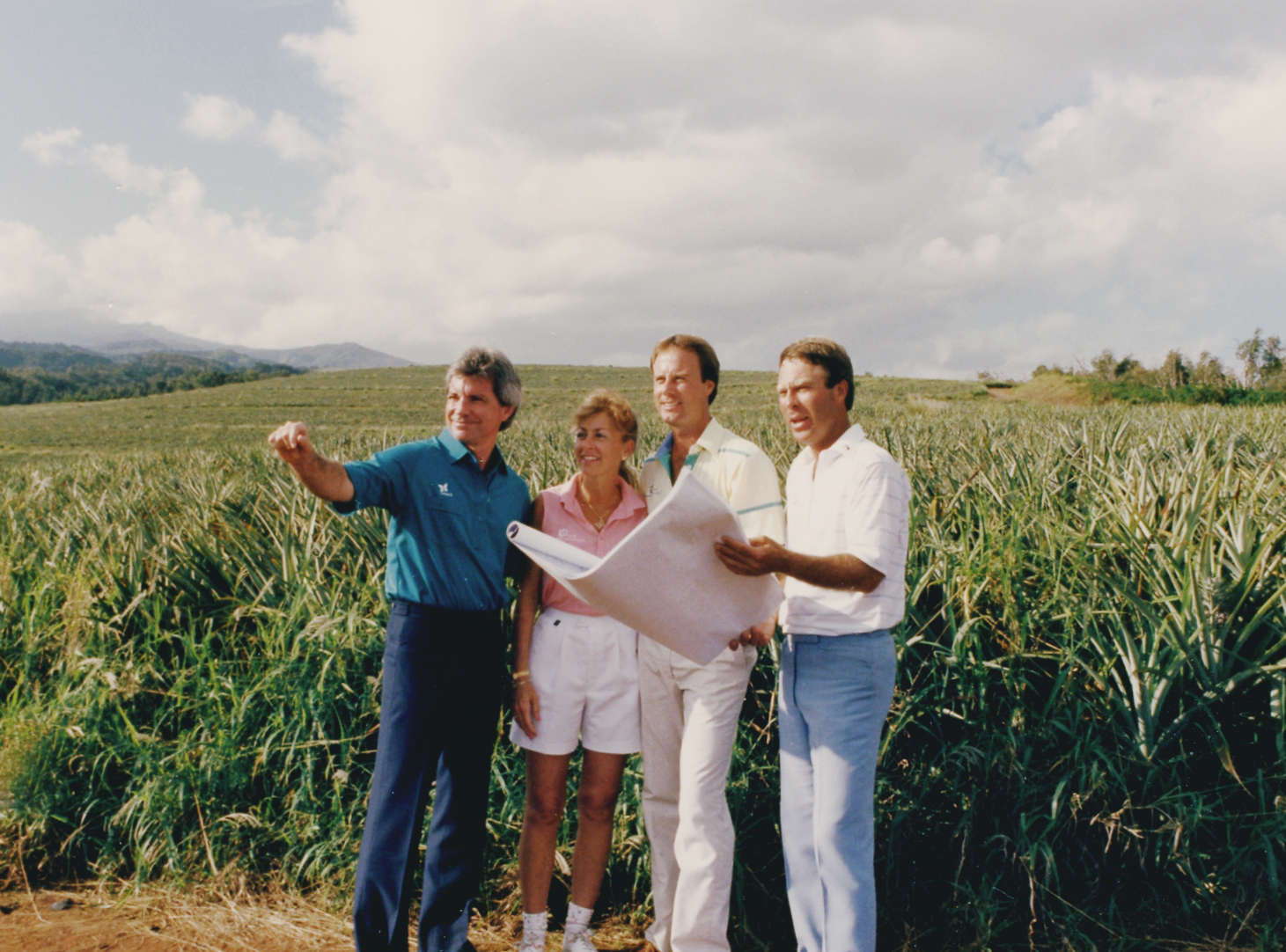 From left, Bill Coore, Debi Rolfing, Mark Rolfing, and Ben Crenshaw review plans for the Kapalua Plantation Course in this 1987 photo. Courtesy photo