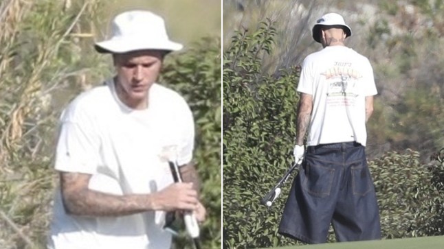 Justin Bieber caught weeing in the bushes on Palm Springs golf course. He's wearing a white T-shirt and bucket hat and oversized jean shorts