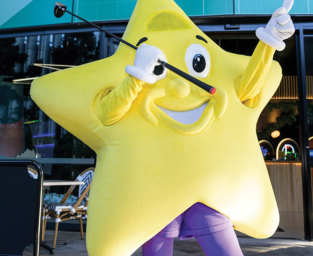 Matt Newton swings at X-Golf for Starlight Foundation