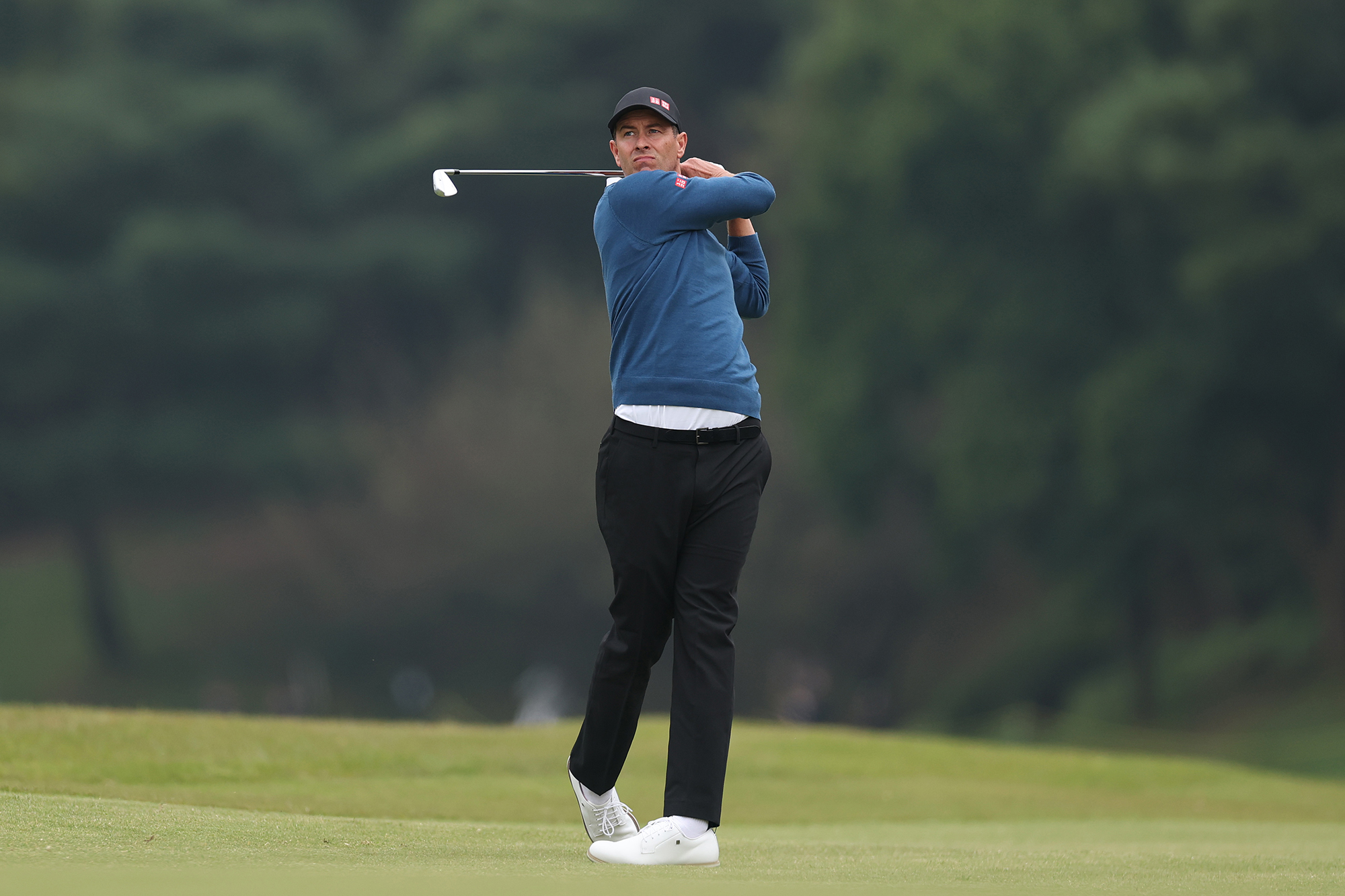 Adam Scott in the finish position with an iron