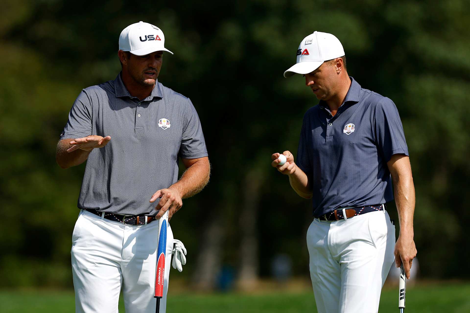 FARMINGDALE, NEW YORK - SEPTEMBER 23: Bryson DeChambeau of Team United States talks with Justin Thomas of Team United States on the 13th hole prior to the Ryder Cup 2025 at Black Course at Bethpage State Park Golf Course on September 23, 2025 in Farmingdale, New York. (Photo by Harry How/Getty Images)
