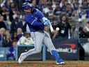 Ty France #2 of the Toronto Blue Jays hits a single during the 10th inning against the Los Angeles Dodgers in game three of the 2025 World Series at Dodger Stadium on October 27.