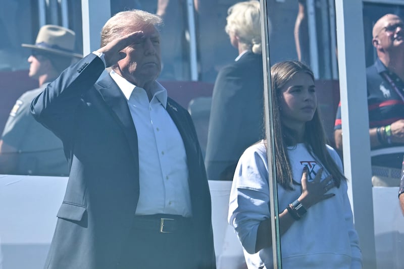 FARMINGDALE, NEW YORK - SEPTEMBER 26: U.S. President Donald Trump, along with his granddaughter Kai Madison Trump, attends the 2025 Ryder Cup at Black Course at Bethpage State Park Golf Course on September 26, 2025 in Farmingdale, New York. In his second term, Trump has attended several major sporting events.  (Photo by Mandel Ngan-Pool/Getty Images)