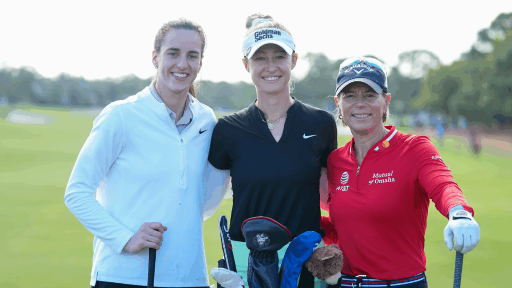 Caitlin Clark stands on the fairway with fellow golfers during The ANNIKA driven by Gainbridge Pro-Am at Pelican Golf Club in Belleair, Florida.