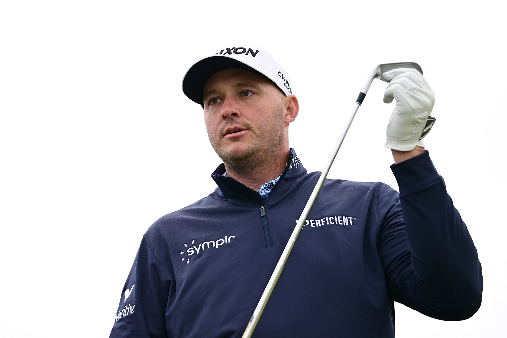 Sepp Straka holding the clubface with his glove hand while watching the golf ball in the air