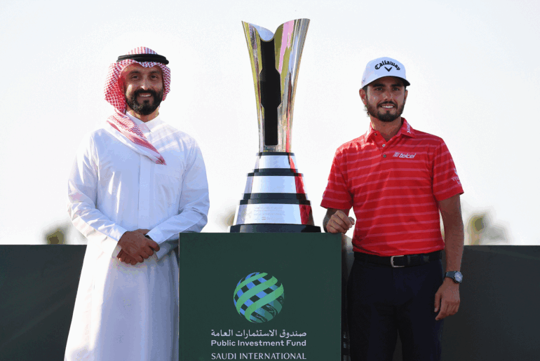 Noah Alireza (left) and Abraham Ancer stand either side of the PIF Saudi International trophy in 2024