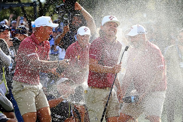 DALLAS, TEXAS - SEPTEMBER 22: Cameron Smith of Australia and The Ripper GC team is soaked with champagne by his teammates Lucas Herbert, Marc Leishman and Matt Jones after holing teh winning putt on the 18th green during the individual team stroke-play finals on day three of the LIV Golf Team Championship Dallas at Maridoe Golf Club on September 22, 2024 in Dallas, Texas. (Photo by David Cannon/Getty Images)