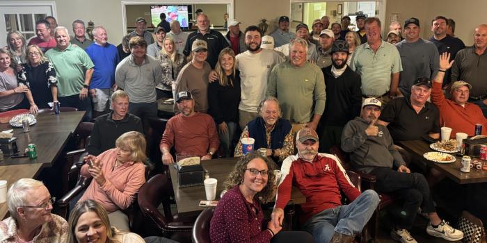 Kip Henley (center, in olive green shirt) is surrounded by family and friends at Creeks Bend for Thursday night