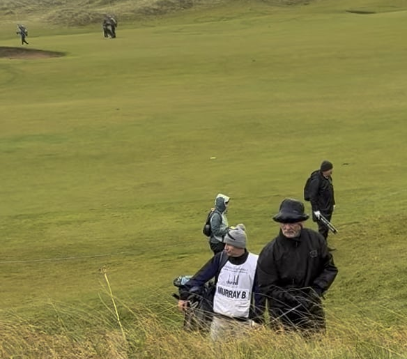 Bill Murray almost injuring himself hitting out of the rough.