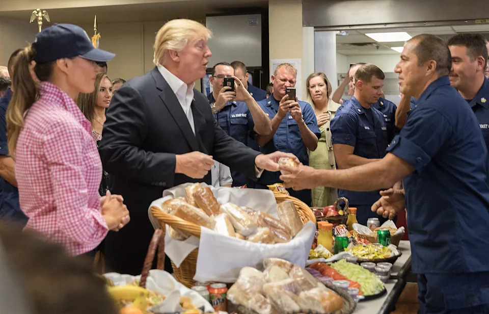 President Donald Trump and First Lady Melania Trump hand out sandwiches to members of the Coast Guard during their visit to the U.S. Coast Guard, at the Lake Worth Inlet Station, on Thanksgiving, Thursday, Nov. 23, 2017, in Riviera Beach