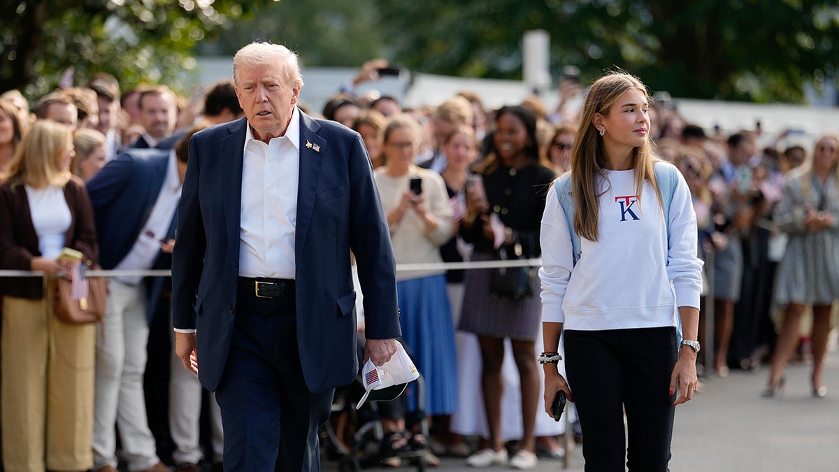Donald Trump and Kai Trump walk