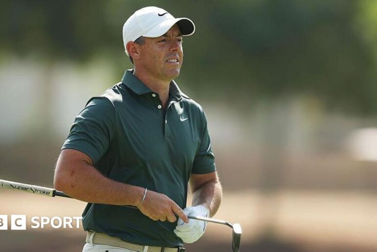 Rory McIlroy holding a putter