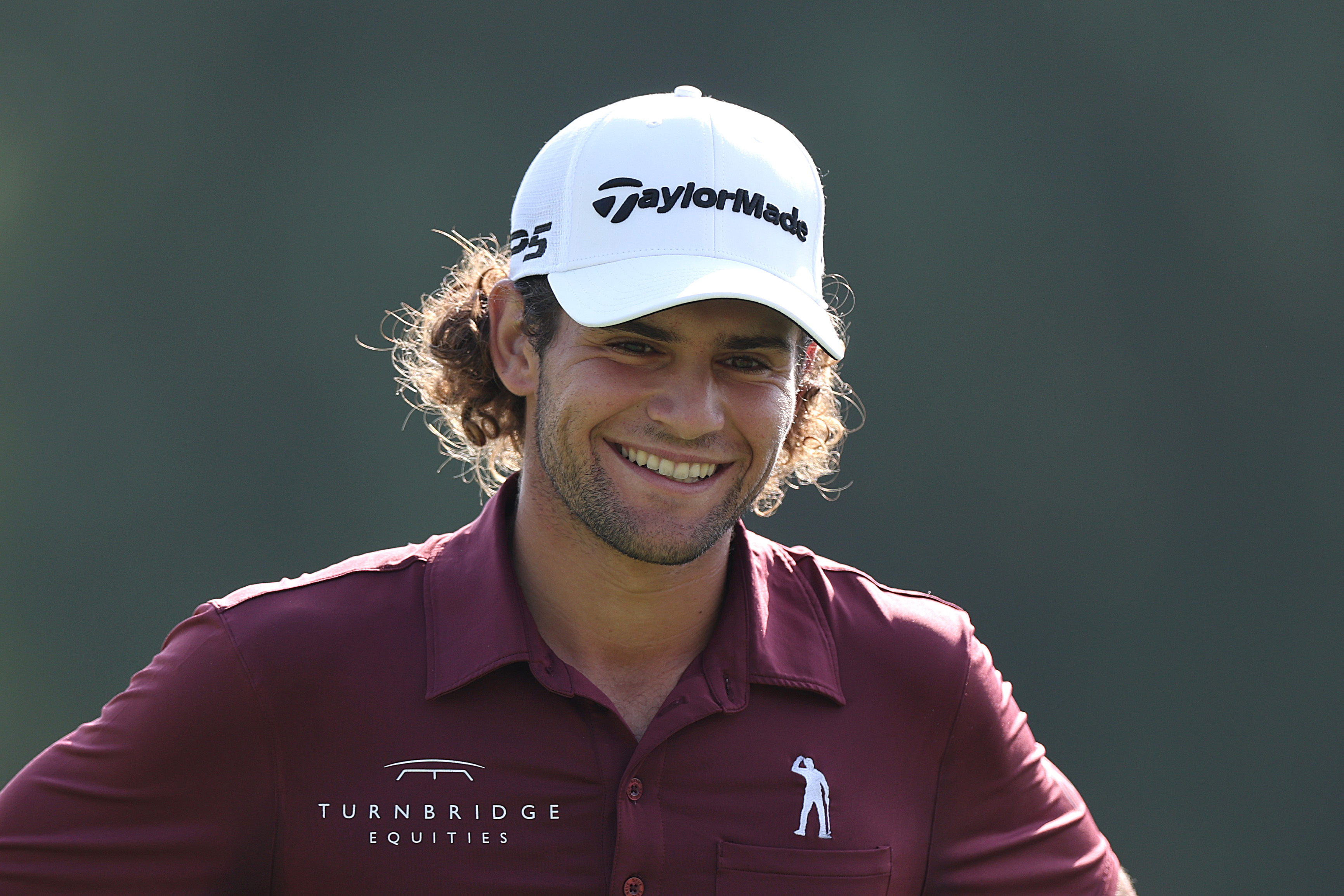 Angel Ayora laughs while walking down the fairway