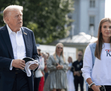 US President Donald Trump (left) walks alongside his granddaughter Kai