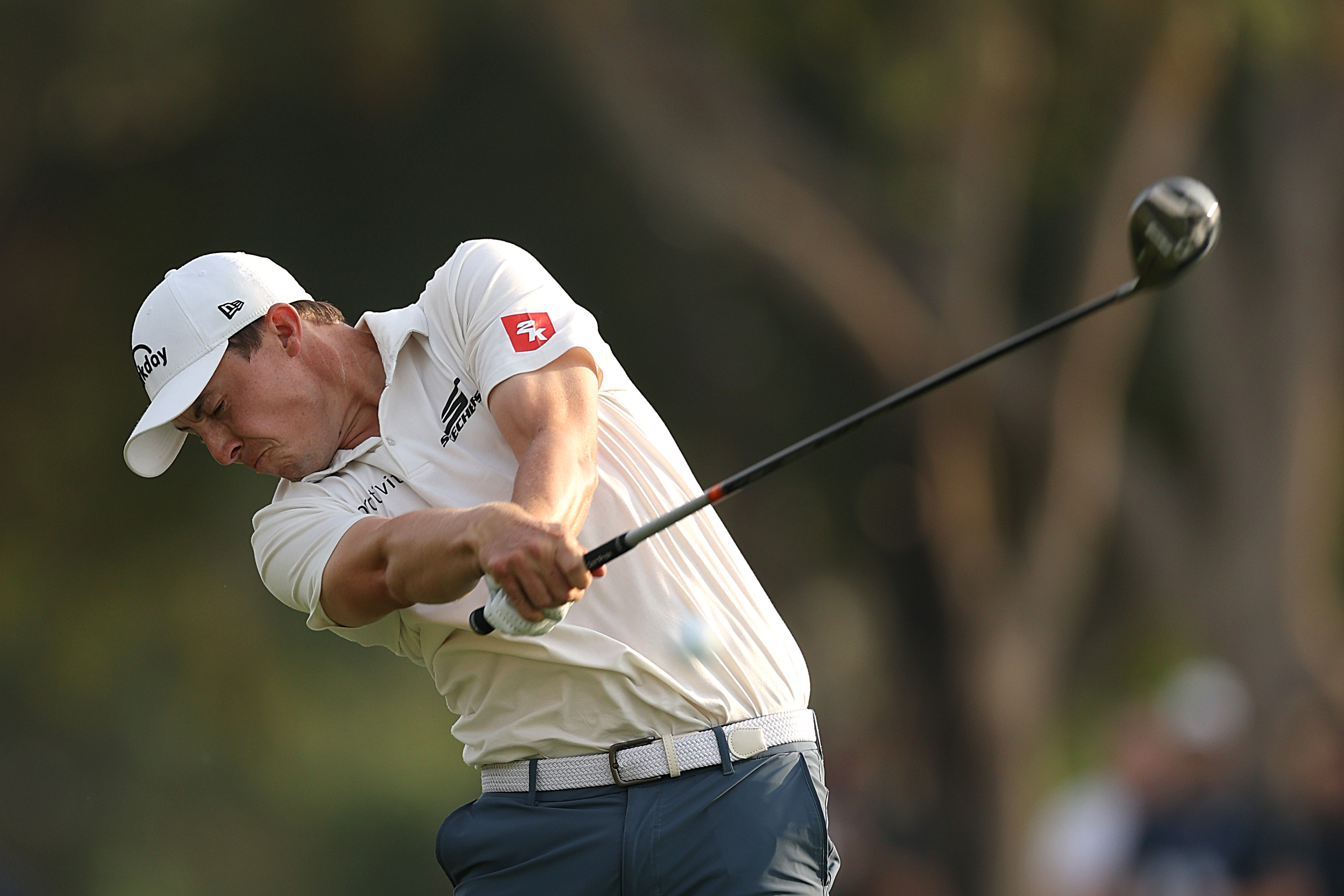 Matt Fitzpatrick hits a fairway wood from the fairway