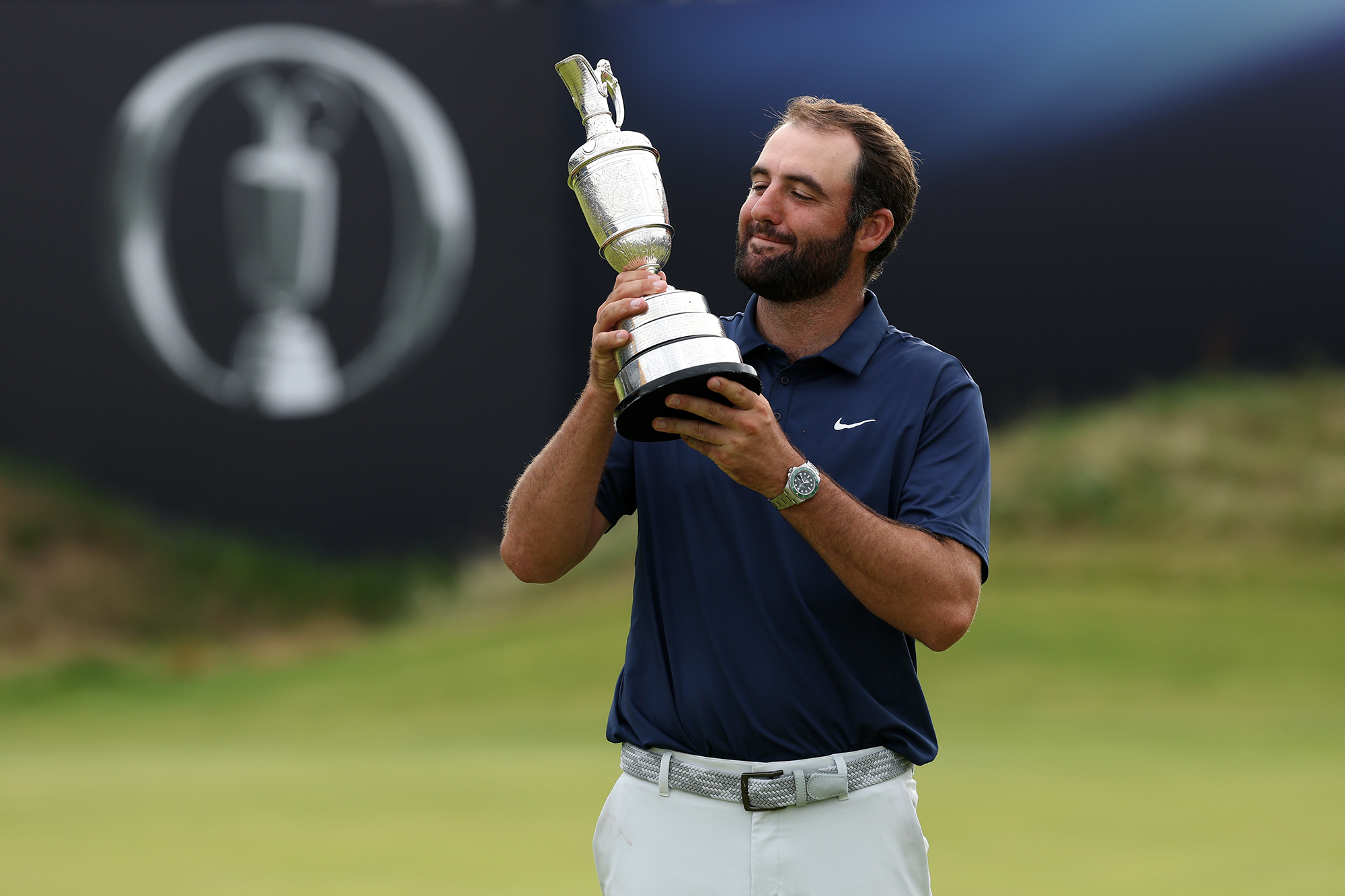 Scottie Scheffler holding the claret jug after winning the open championship in 2025