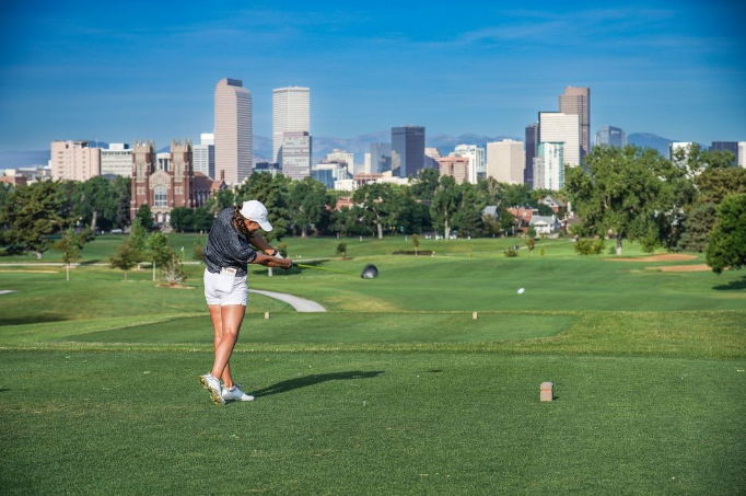 golfer tees off at city Park Golf course in denver