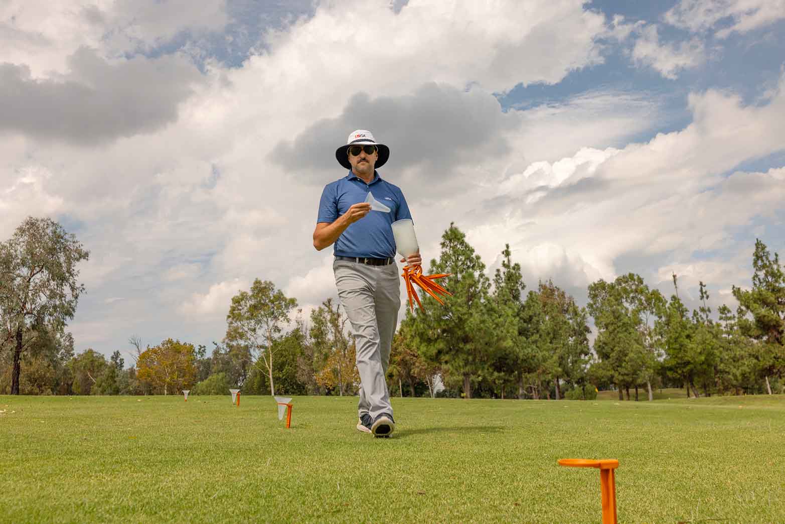 Serena places Catch Cans on a hole at Los Serranos.