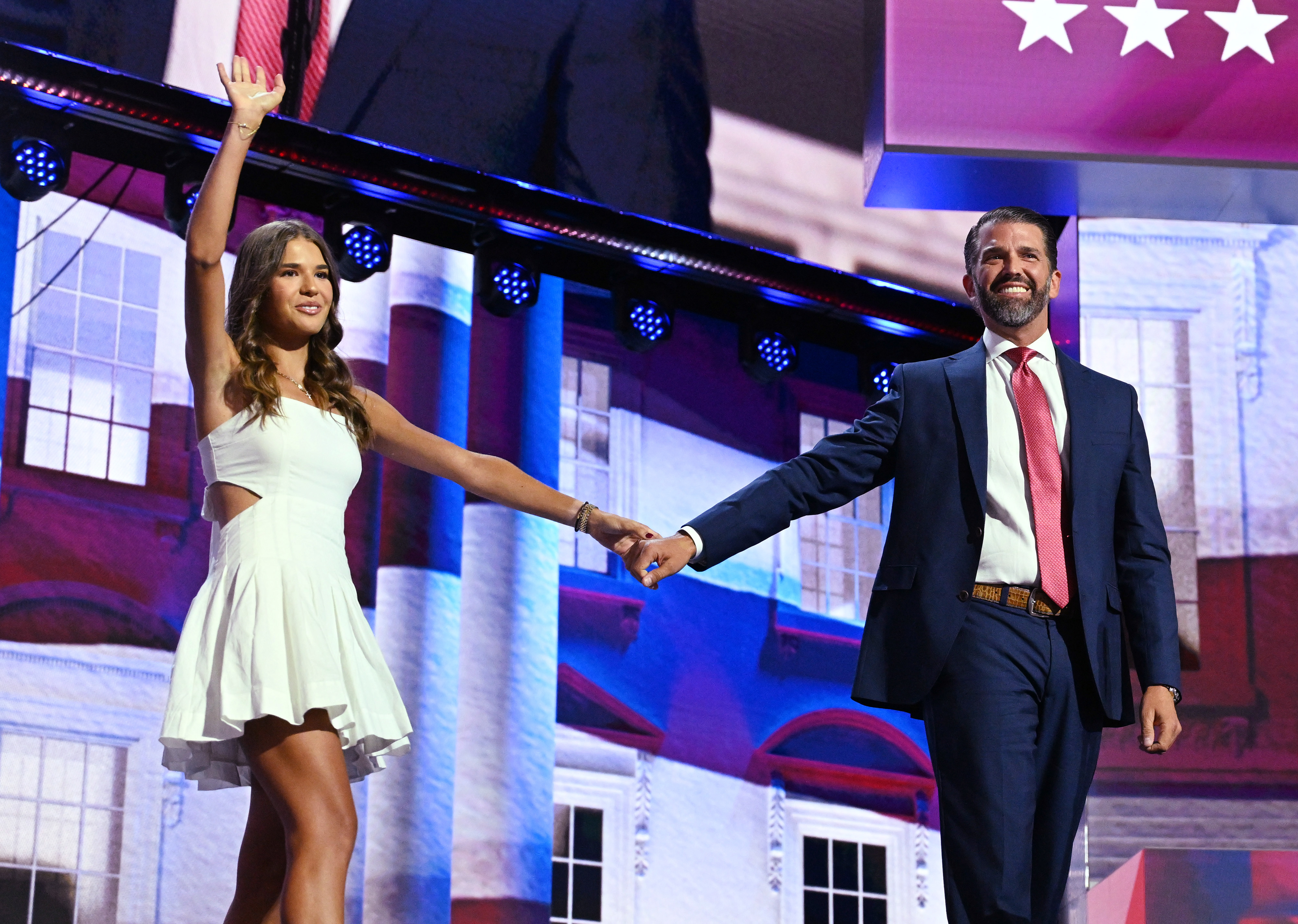 Kai Madison Trump waves, holding her father Donald Trump Jr.'s hand, at the 2024 Republican National Convention.