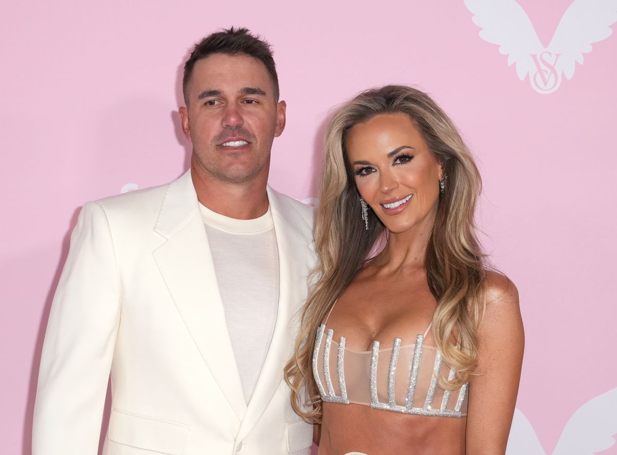 Brooks Koepka and Jena Sims pose on a red carpet