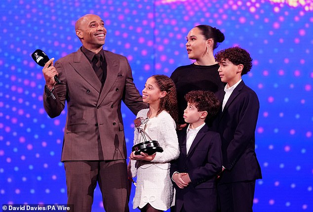 Former Arsenal star Thierry Henry celebrates his lifetime achievement award with his children