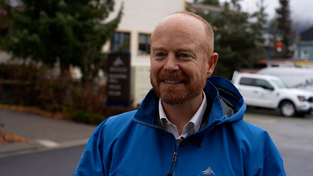 man standing in a blue jacket