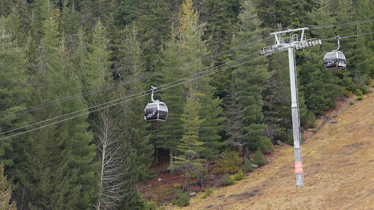 a ski resort gondola with green hillside