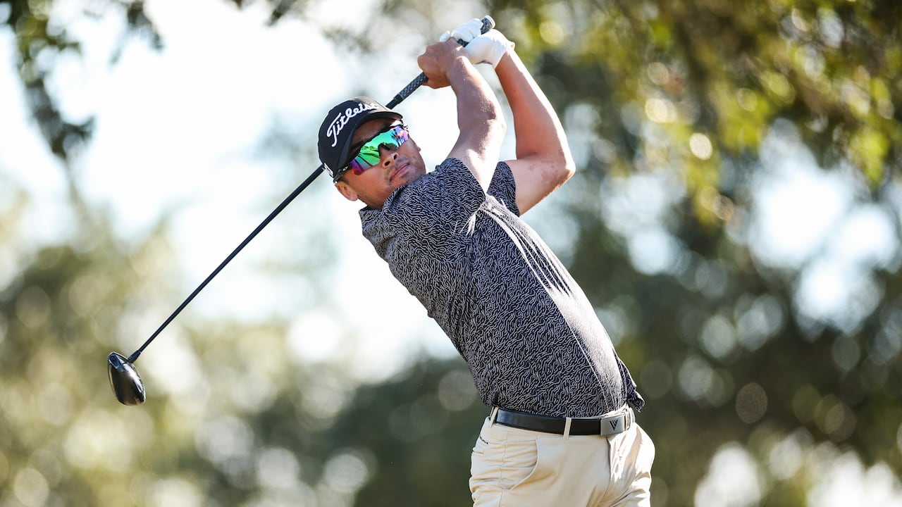 A man swings a driver.